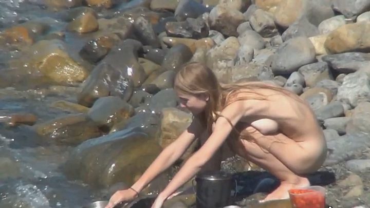 Nudist family enjoys beach activities video
