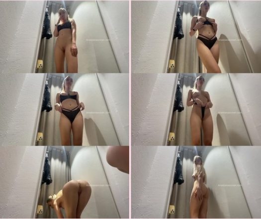 In the fitting room-tries on new clothes on her naked body