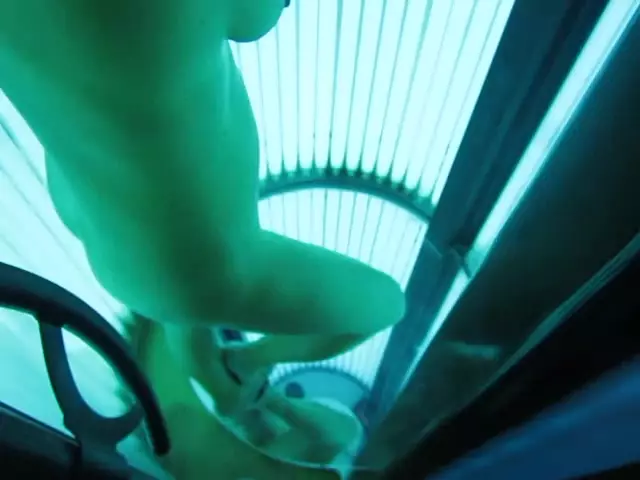Spying on naked woman in tanning machine