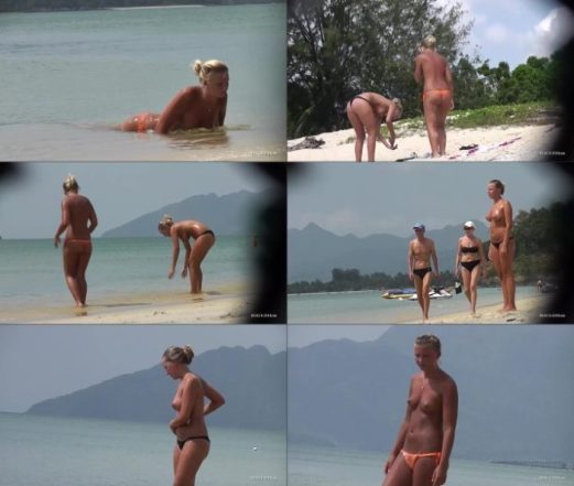 Mother and daughter topless on beach