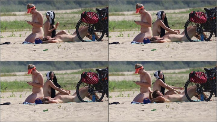 Bored girl on a nudist beach