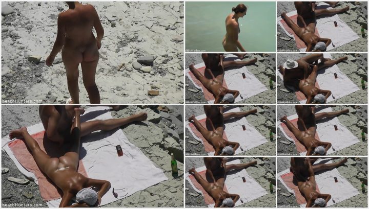 Nudist man likes to touch his naked wife on beach