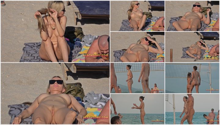 Shiny body of hot nudist woman on beach