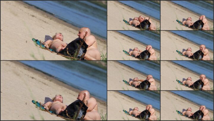 Nudist couple relaxes at the beach